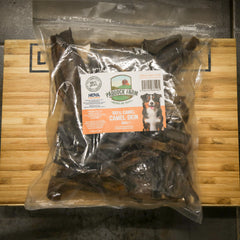Package of Paddock Farm camel skin treats on a wooden surface