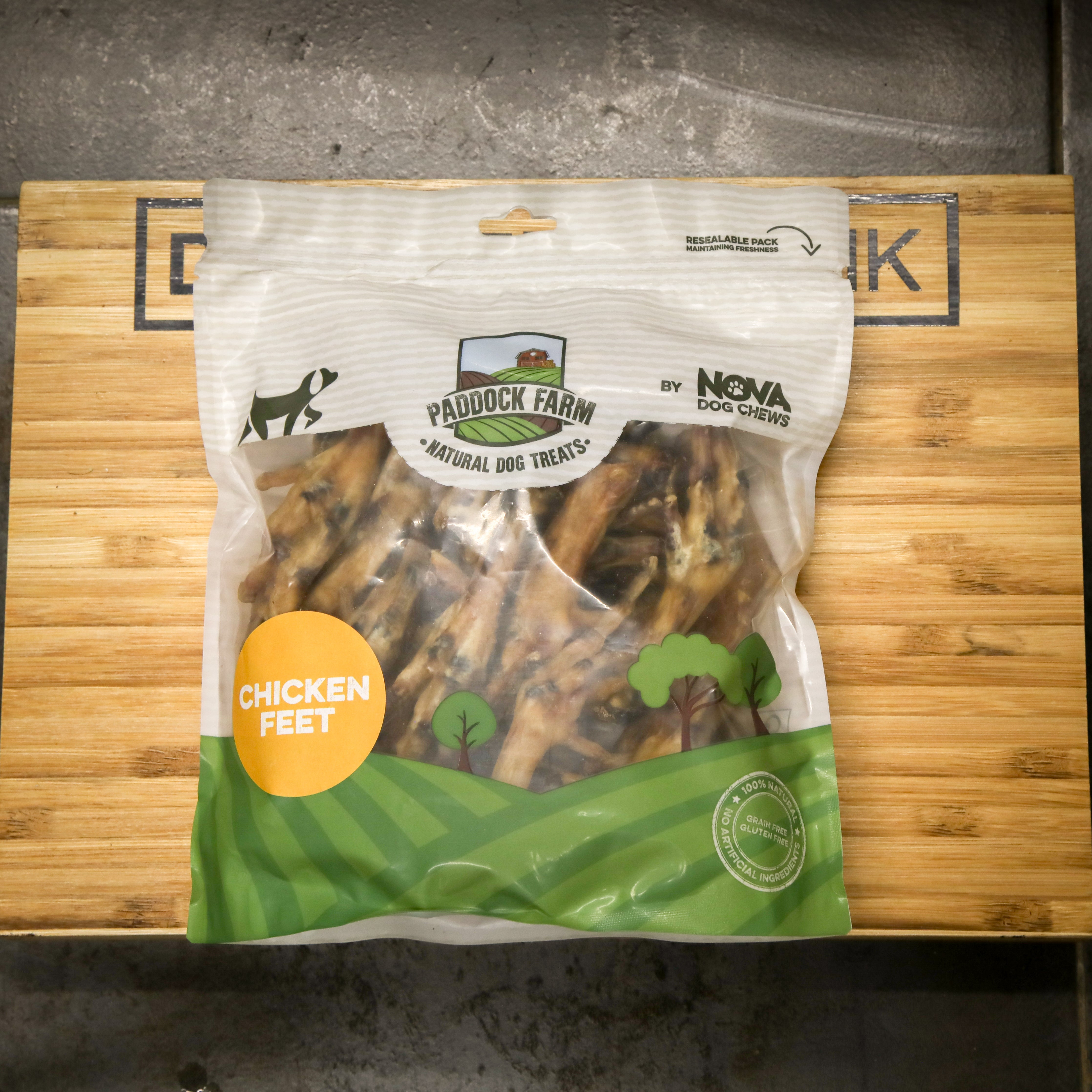Package of Paddock Farm Nova Dog Chews chicken feet treats on a wooden surface