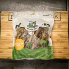 Package of Paddock Farm Nova Dog Chews chicken feet treats on a wooden surface