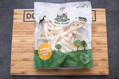 Puffed chicken feet from nova chews on a dog centre mk branded wooden board