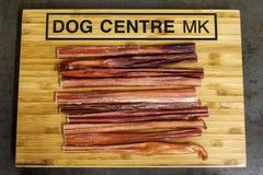 multiple bull pizzle on a dog centre mk branded wooden board
