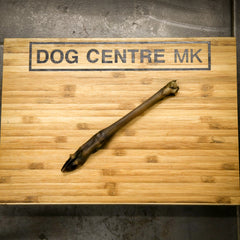 Baby deer leg on a wooden board with 'DOG CENTRE MK' branding