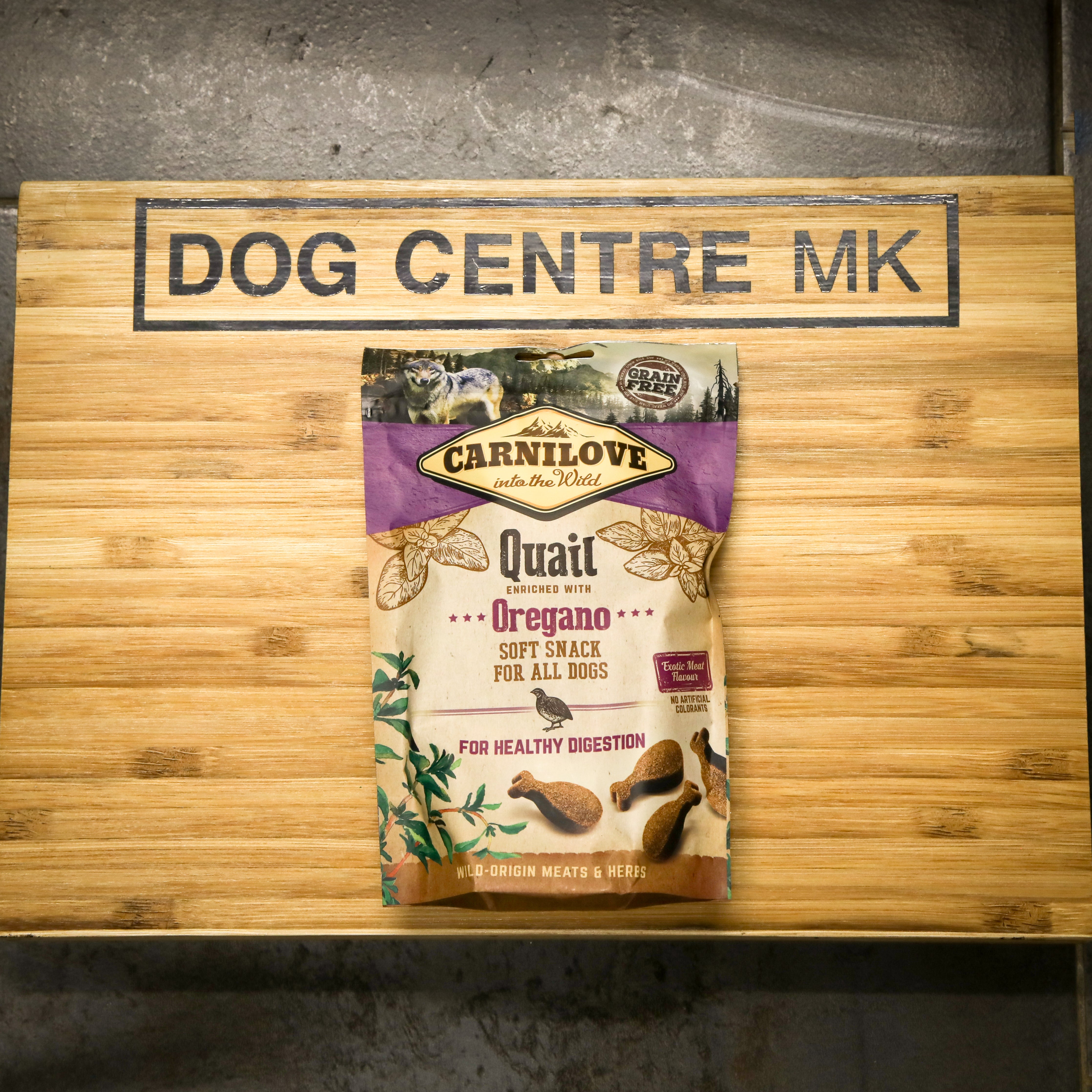 CarniLove dog food package on a wooden board with 'Dog Centre MK' branding.