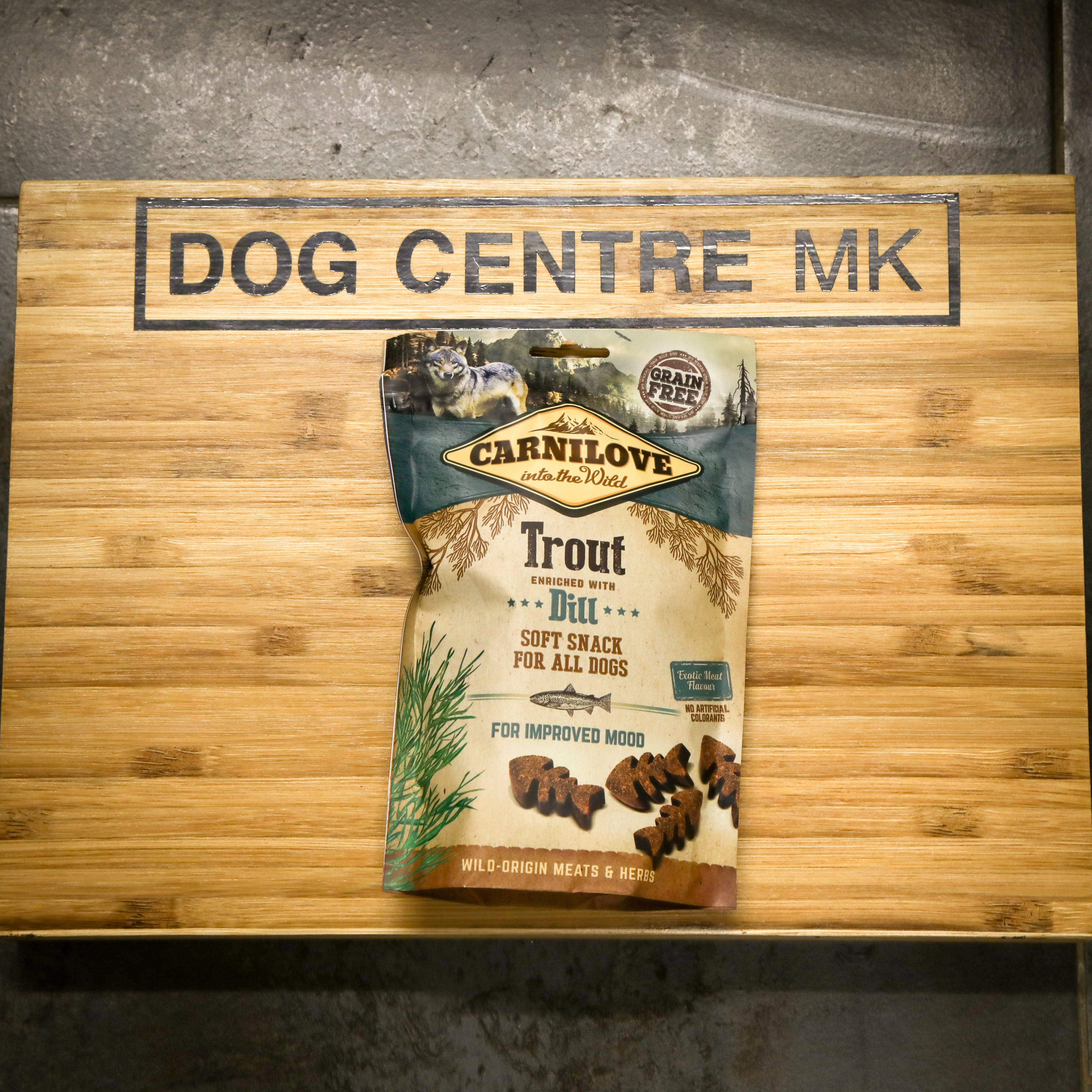 Carnilove dog food package on a wooden board with 'Dog Centre MK' branding.