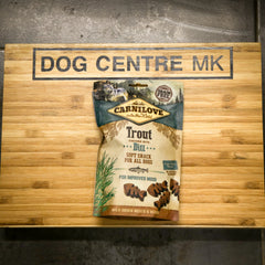 Carnilove dog food package on a wooden board with 'Dog Centre MK' branding.