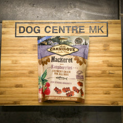 Carnilove dog food package on a wooden board with 'Dog Centre MK' branding.