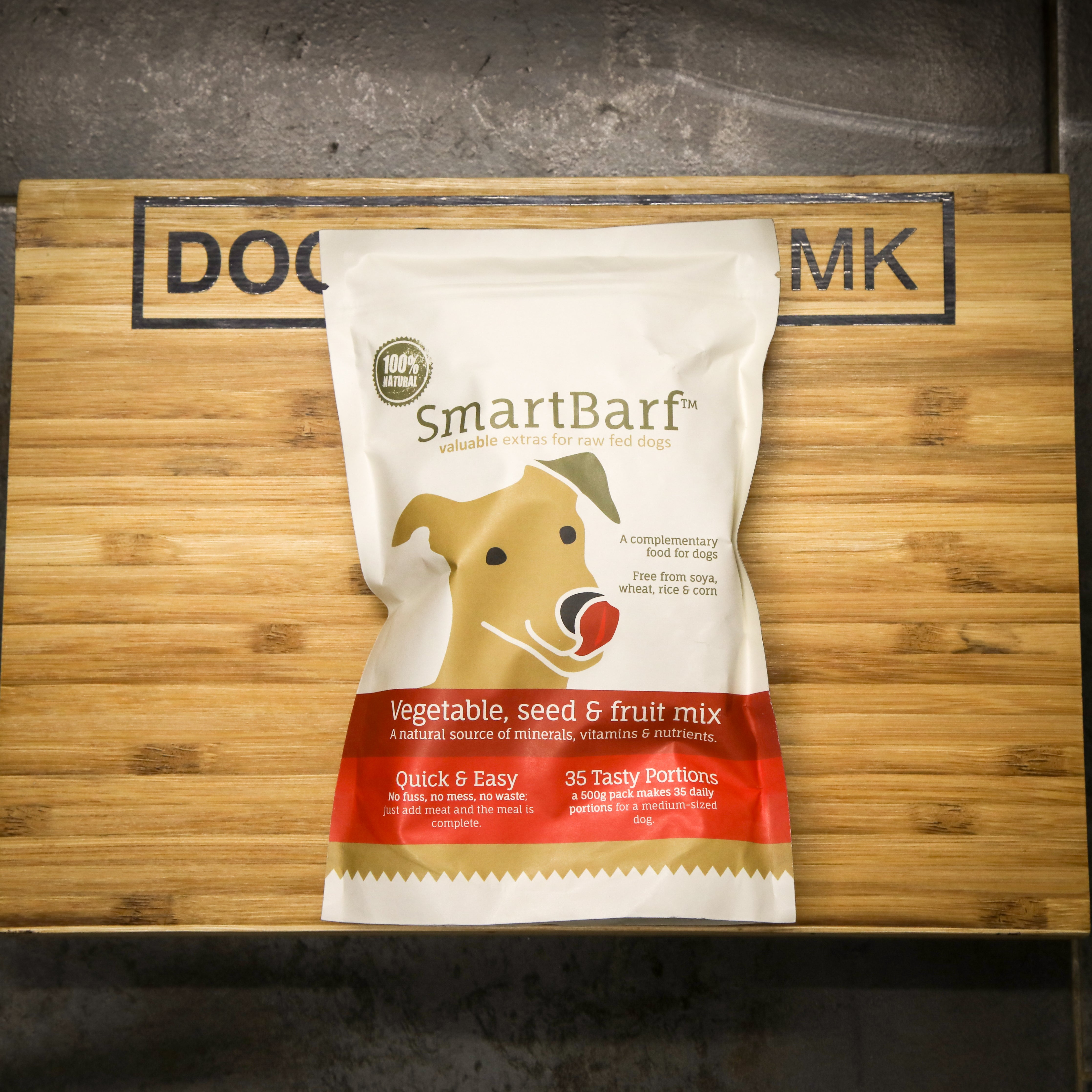 SmartBarf dog food vegetagble, seed and fruit mix package on a wooden surface with 'DOG CENTRE MK' branding.