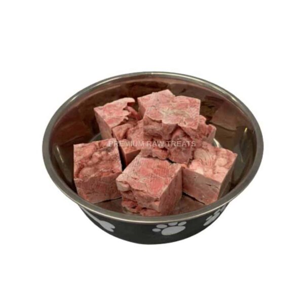 Chicken gizzard chunks in a dog bowl on white background